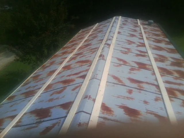 Rusted metal roof panels with new wood purlins before replacement — Storm Damage Roof Repair in Hubbard by Roofing Brothers